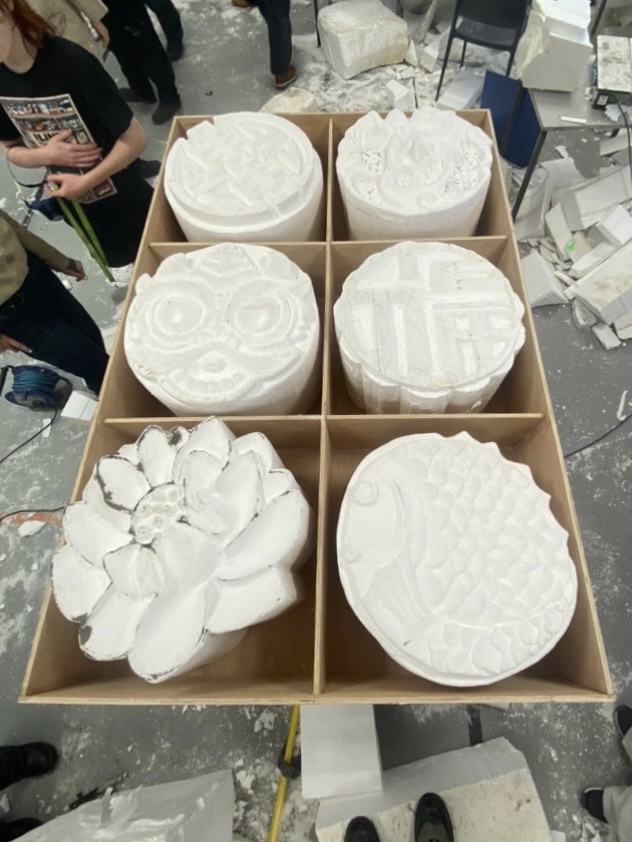 Polycarved mooncakes in their box before painting