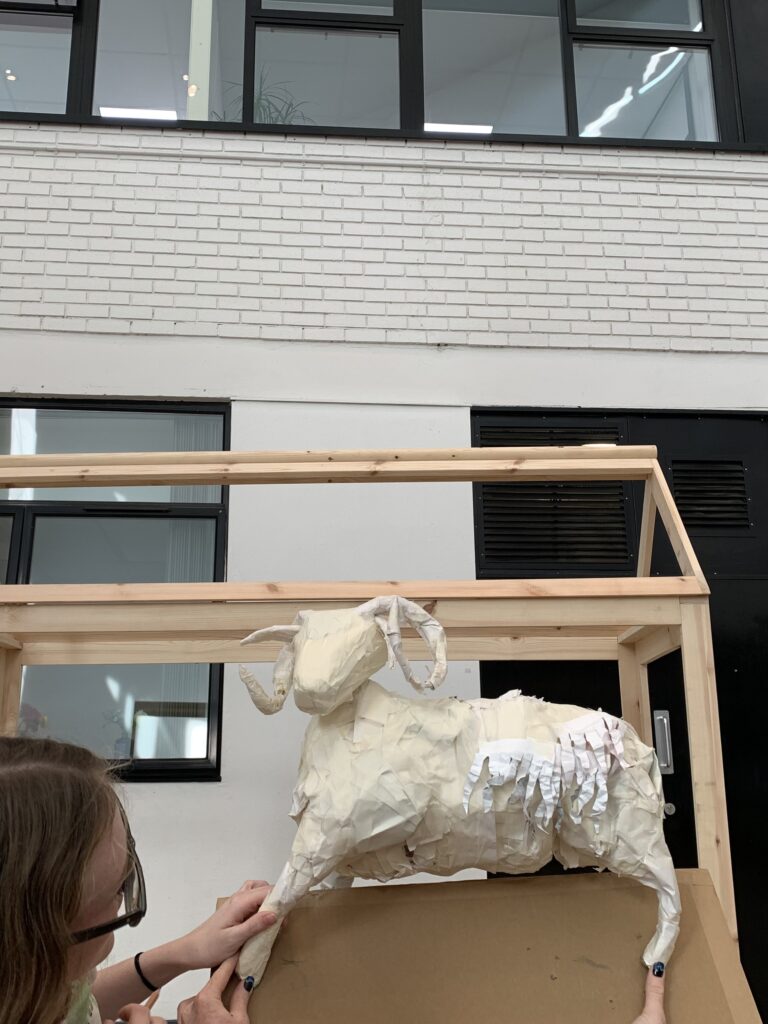 Next to the frame of the wall