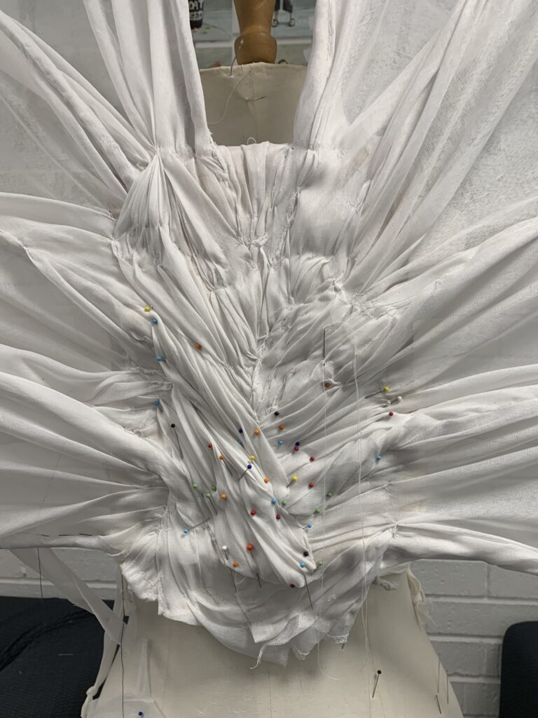 Gathering fabric into interesting folds to hide the base board