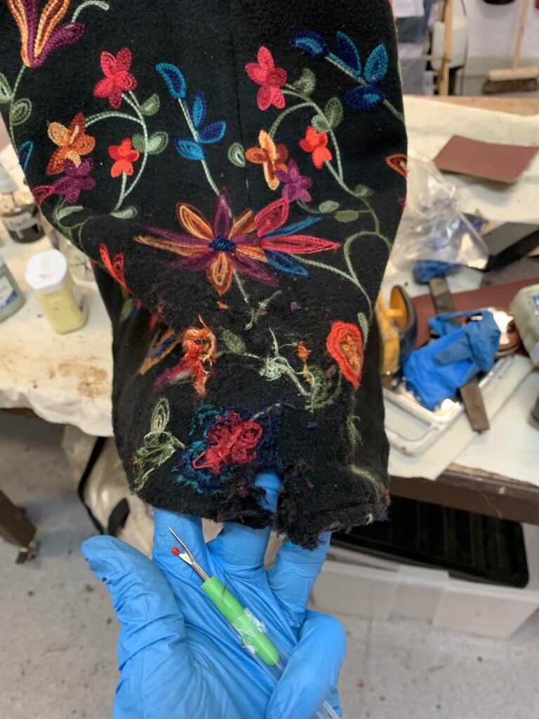 Designer wanted a snag on the hem, as though she had caught and torn it on a machine