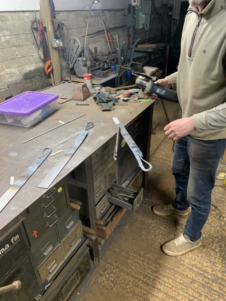Angle grinding off excess metal once the handle is formed