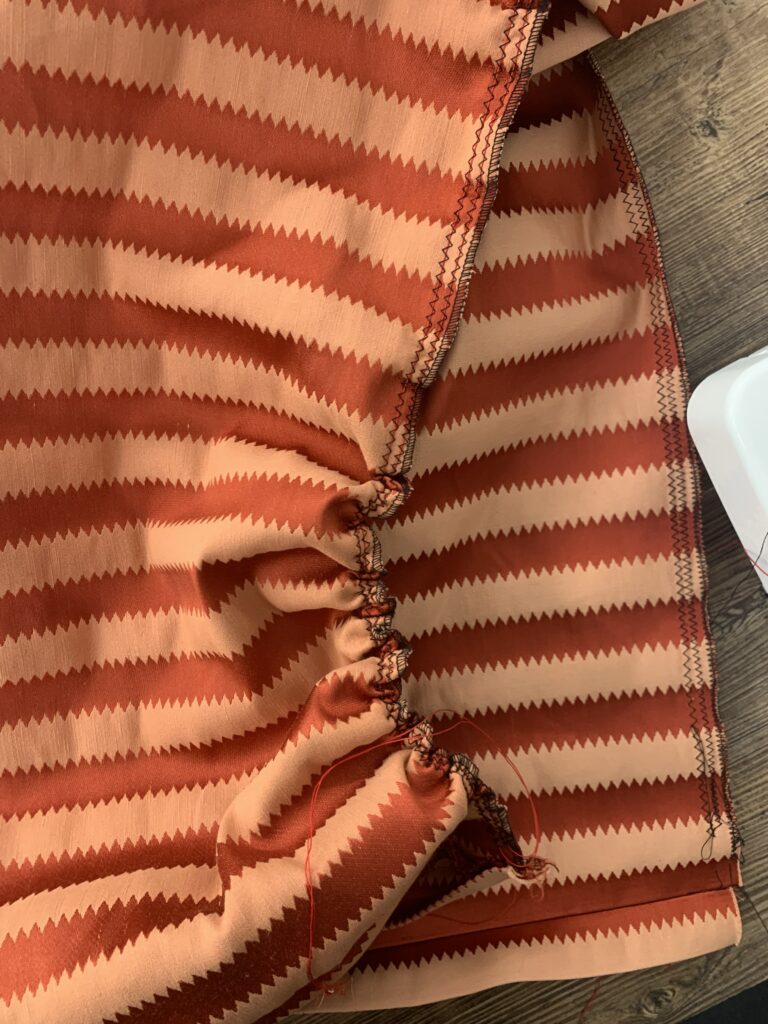 Gathering skirt fabric with button thread to support heavy fabric